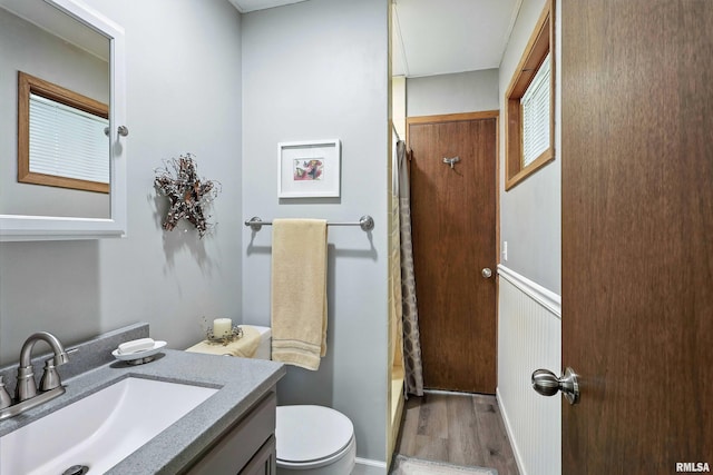 28002 230th St, Le Claire, IA 52753 - full bathroom featuring vanity, wood finished floors, and a wainscoted wall