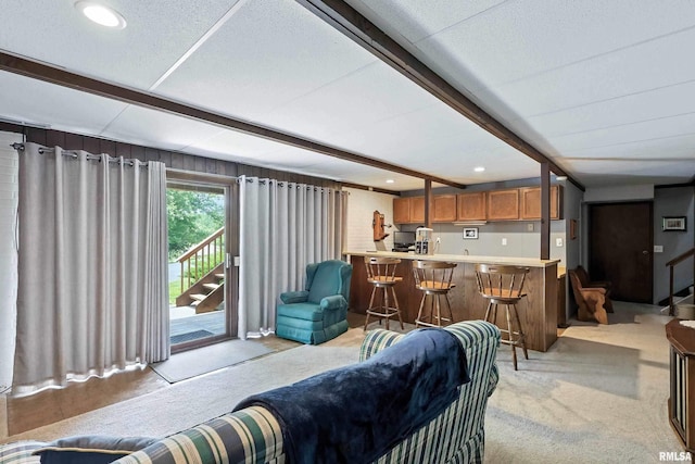 28002 230th St, Le Claire, IA 52753 - living area featuring beam ceiling, stairway, light colored carpet, recessed lighting, and bar