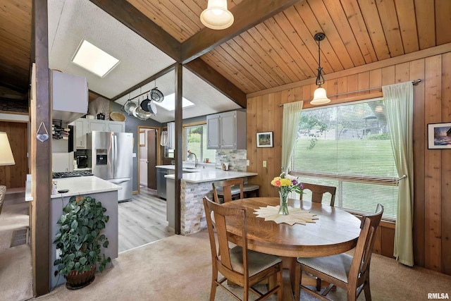 28002 230th St, Le Claire, IA 52753 - dining room featuring wooden walls, light colored carpet, and wood ceiling