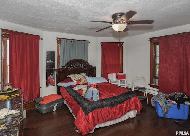 1610 12th Ave, Rock Island, IL 61201 - bedroom featuring wood finished floors, baseboard heating, a textured ceiling, and ceiling fan
