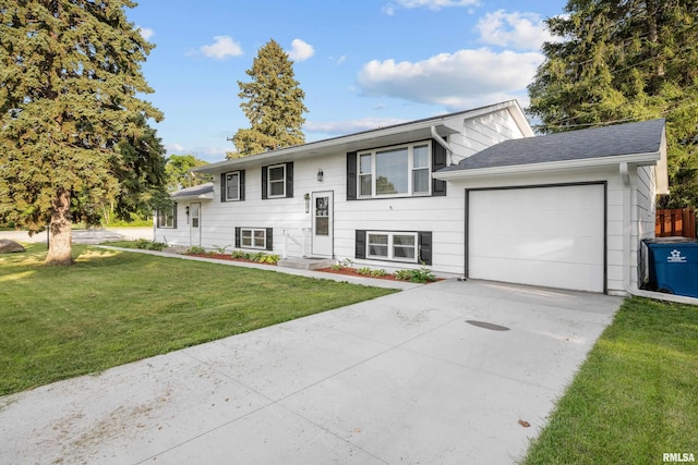 101 W Sheridan Dr, Eldridge, IA 52748 - raised ranch featuring a garage, a front lawn, and driveway