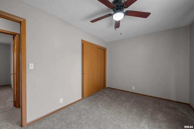 101 W Sheridan Dr, Eldridge, IA 52748 - unfurnished bedroom with carpet flooring, a textured ceiling, a closet, and ceiling fan