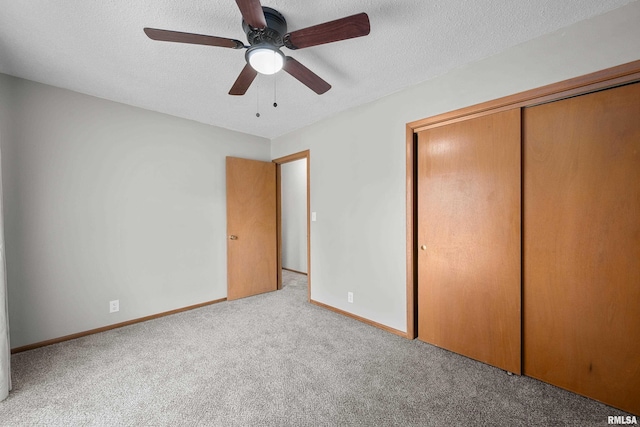 101 W Sheridan Dr, Eldridge, IA 52748 - unfurnished bedroom with carpet, a closet, a textured ceiling, and ceiling fan