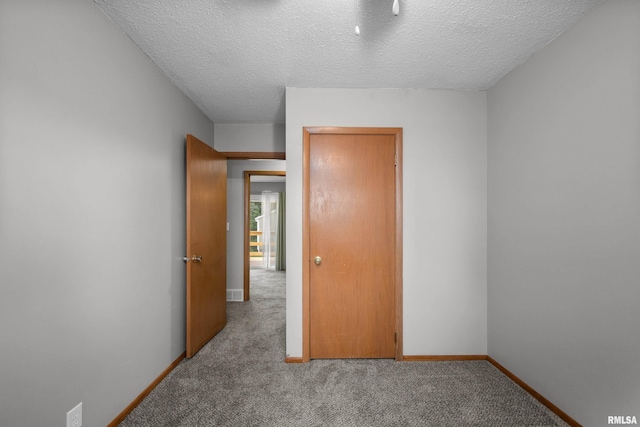 101 W Sheridan Dr, Eldridge, IA 52748 - carpeted spare room featuring a textured ceiling