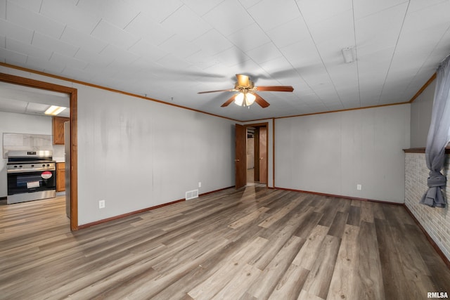 101 W Sheridan Dr, Eldridge, IA 52748 - unfurnished living room featuring a ceiling fan, light wood-style floors, and ornamental molding