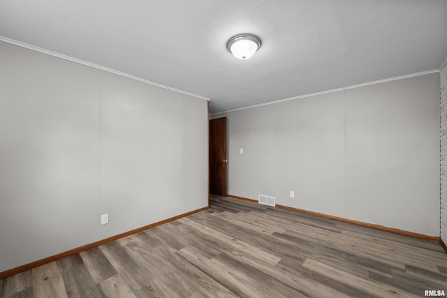 101 W Sheridan Dr, Eldridge, IA 52748 - empty room featuring ornamental molding and wood finished floors