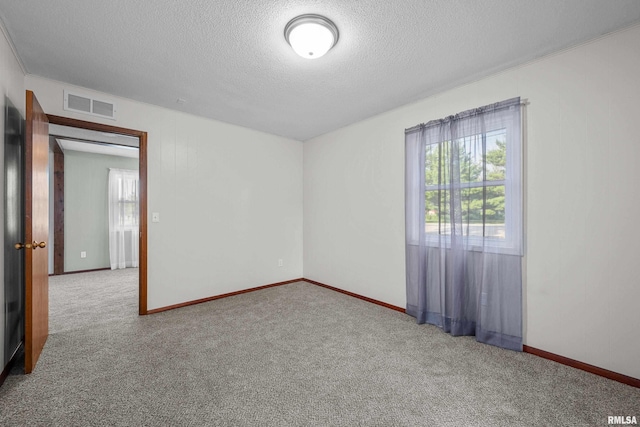 101 W Sheridan Dr, Eldridge, IA 52748 - spare room featuring a textured ceiling and carpet floors