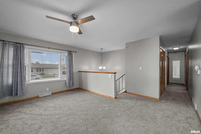 101 W Sheridan Dr, Eldridge, IA 52748 - carpeted empty room featuring a textured ceiling and ceiling fan