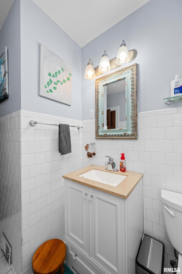 3110 Jefferson Ave, Davenport, IA 52803 - bathroom with tile walls, vanity, and a wainscoted wall