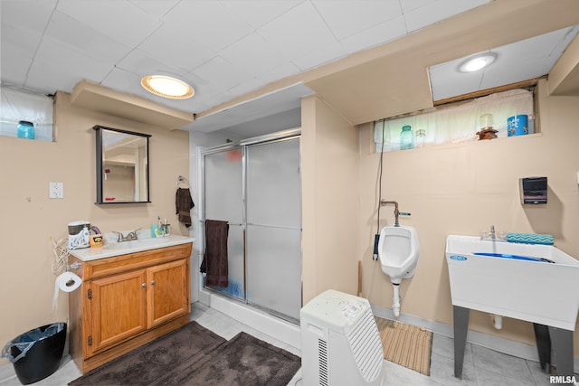 3110 Jefferson Ave, Davenport, IA 52803 - full bathroom featuring a stall shower, tile patterned flooring, and vanity