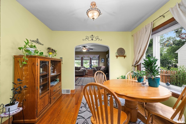 3110 Jefferson Ave, Davenport, IA 52803 - dining area featuring arched walkways, wood finished floors, and ceiling fan