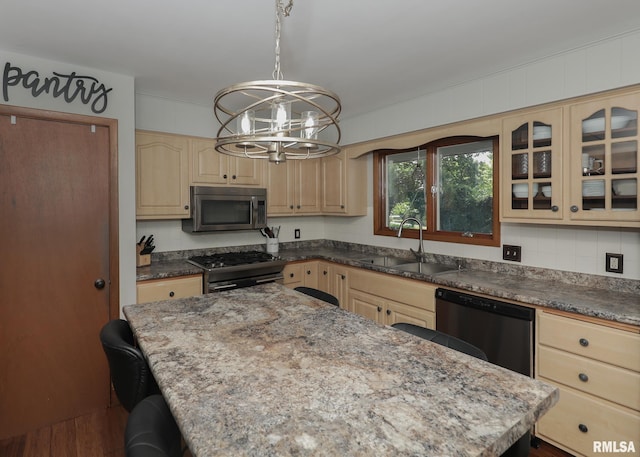 4512 11th Ave Unit C, Moline, IL 61265 - kitchen featuring stainless steel microwave, dishwasher, gas stove, a chandelier, and a kitchen bar