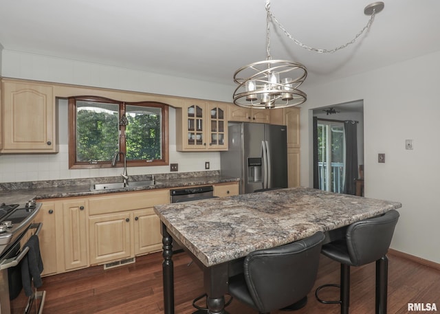 4512 11th Ave Unit C, Moline, IL 61265 - kitchen featuring stainless steel microwave, dishwasher, gas stove, a chandelier, and a kitchen bar