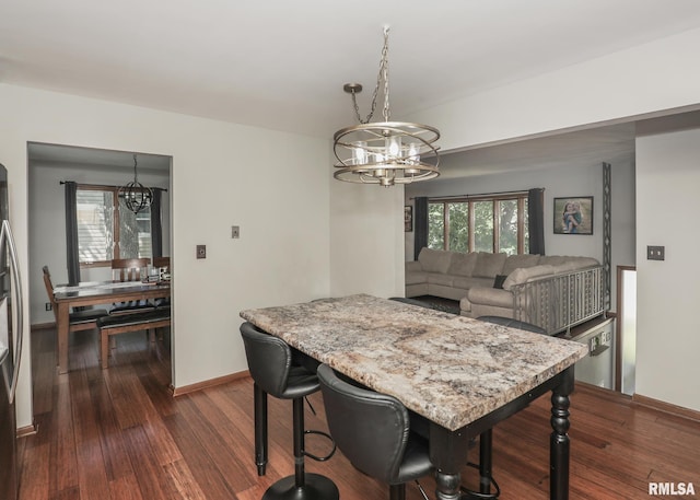 4512 11th Ave Unit C, Moline, IL 61265 - dining space featuring a chandelier and dark wood-type flooring