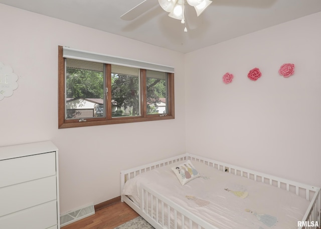 4512 11th Ave Unit C, Moline, IL 61265 - unfurnished bedroom with wood finished floors and a ceiling fan