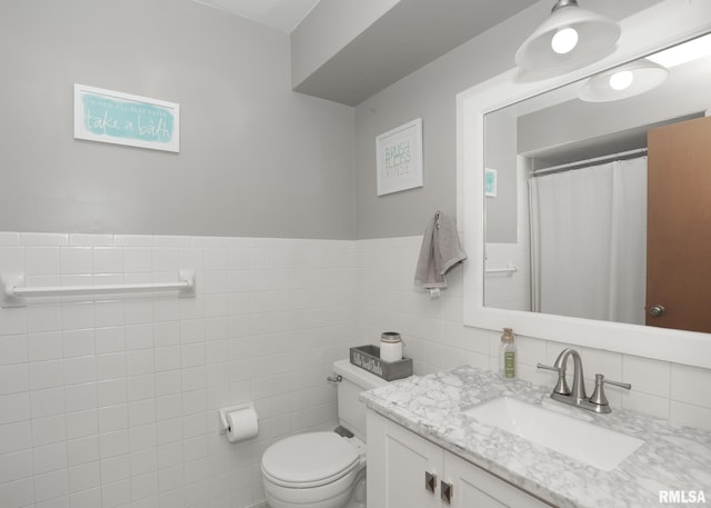 4512 11th Ave Unit C, Moline, IL 61265 - bathroom with vanity, tile walls, and wainscoting