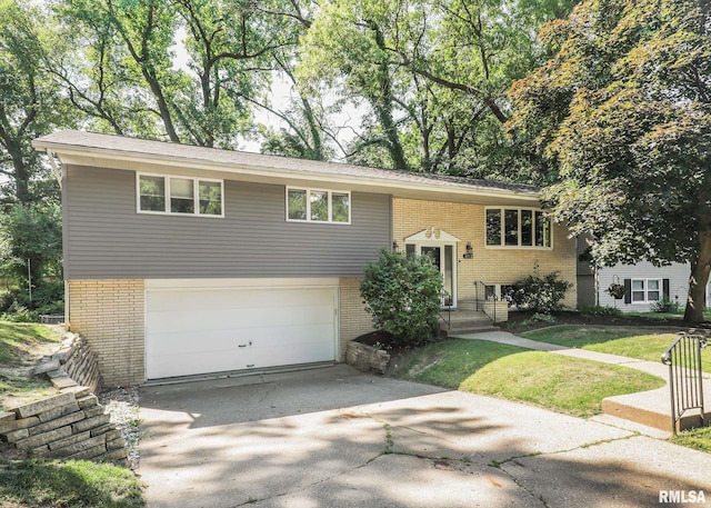 4512 11th Ave Unit C, Moline, IL 61265 - split foyer home featuring brick siding, concrete driveway, and a garage
