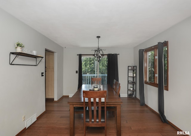 4512 11th Ave Unit C, Moline, IL 61265 - dining space featuring a chandelier and dark wood-type flooring