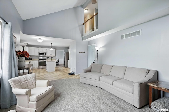 732 W 59th St, Davenport, IA 52806 - living area featuring high vaulted ceiling and light carpet
