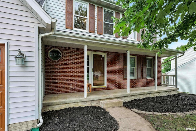 732 W 59th St, Davenport, IA 52806 - doorway to property with a porch and brick siding