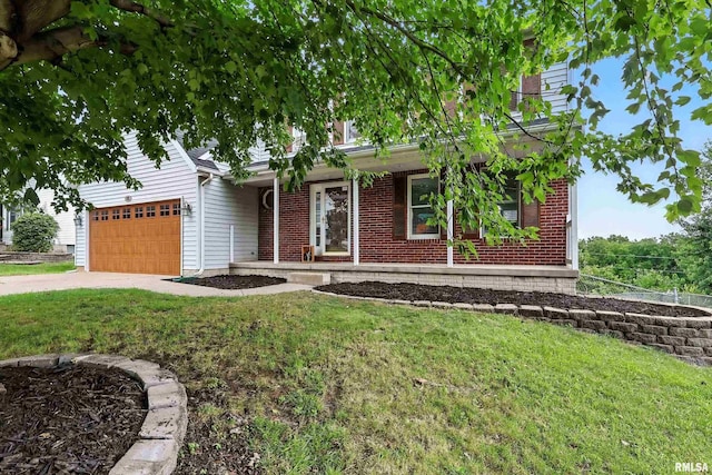 732 W 59th St, Davenport, IA 52806 - view of front facade featuring a front yard, an attached garage, brick siding, and driveway
