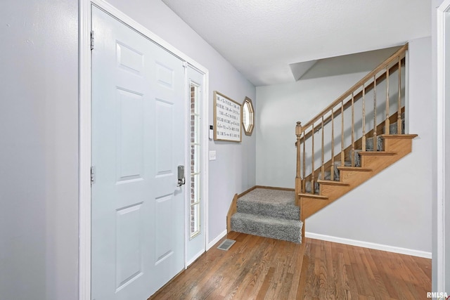 732 W 59th St, Davenport, IA 52806 - entrance foyer featuring stairs and wood finished floors