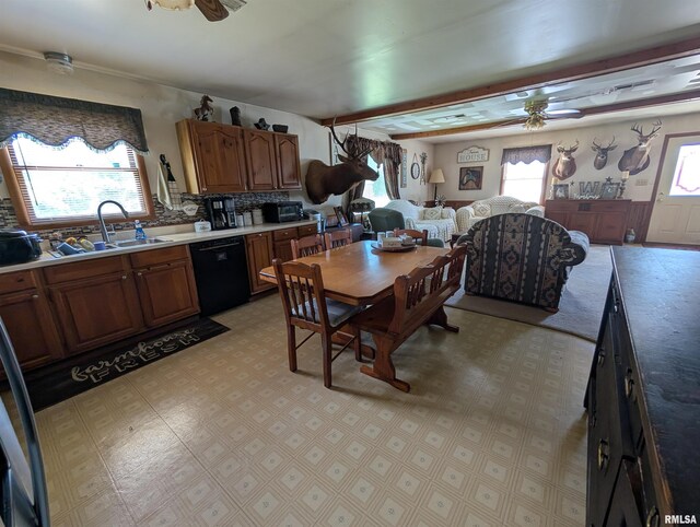 340 Dameron Ln, Vienna, IL 62995 - kitchen with black dishwasher, ceiling fan, backsplash, brown cabinetry, and light countertops