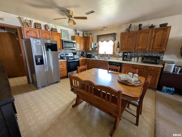 340 Dameron Ln, Vienna, IL 62995 - kitchen with appliances with stainless steel finishes, tasteful backsplash, and light countertops