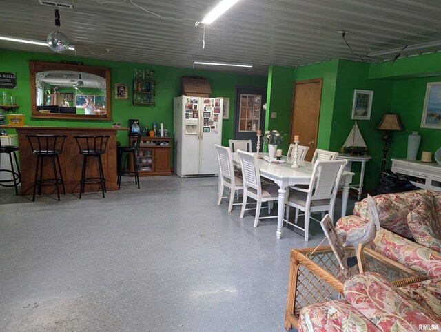 340 Dameron Ln, Vienna, IL 62995 - dining room with speckled floor and a dry bar