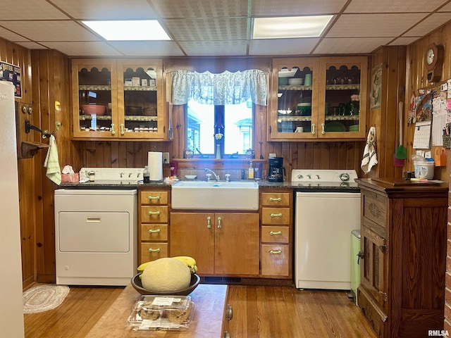 1723 Pershing Blvd, Clinton, IA 52732 - kitchen with washer / clothes dryer, a paneled ceiling, wooden walls, brown cabinetry, and wood finished floors
