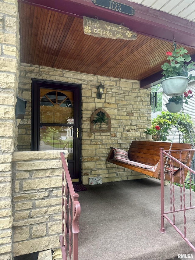 1723 Pershing Blvd, Clinton, IA 52732 - doorway to property featuring stone siding and covered porch