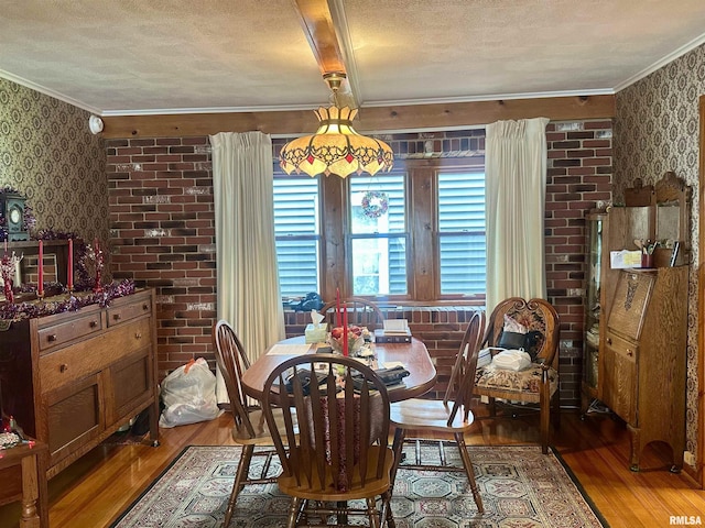 1723 Pershing Blvd, Clinton, IA 52732 - dining space featuring wallpapered walls, wood finished floors, ornamental molding, a textured ceiling, and beamed ceiling