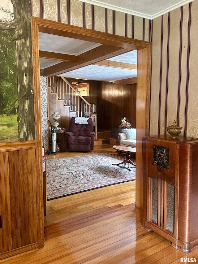 1723 Pershing Blvd, Clinton, IA 52732 - living room featuring wood finished floors, stairs, and wood walls