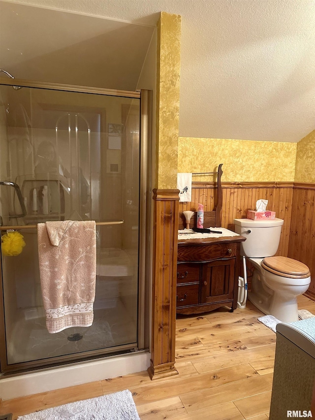 1723 Pershing Blvd, Clinton, IA 52732 - full bathroom featuring wainscoting, hardwood / wood-style flooring, a shower stall, vanity, and wood walls