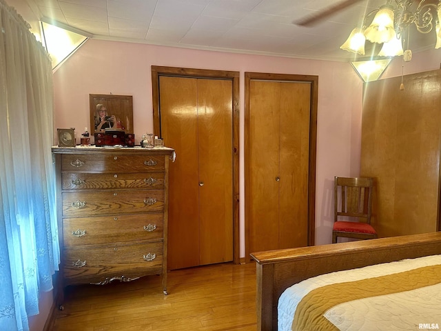 1723 Pershing Blvd, Clinton, IA 52732 - bedroom with light wood-style floors, multiple closets, crown molding, and ceiling fan