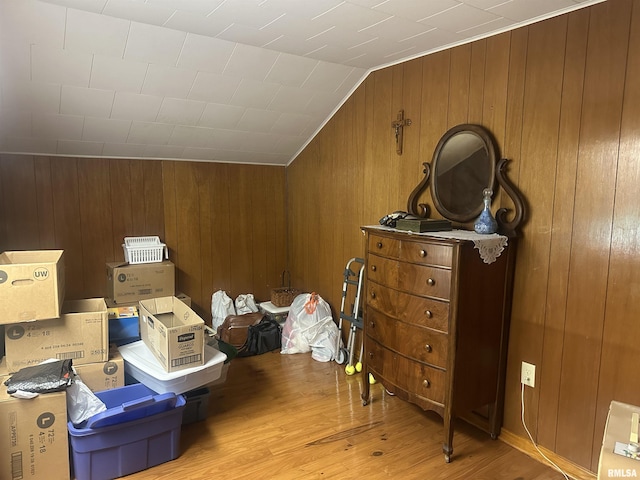 1723 Pershing Blvd, Clinton, IA 52732 - bedroom featuring light wood-style flooring, lofted ceiling, and wood walls