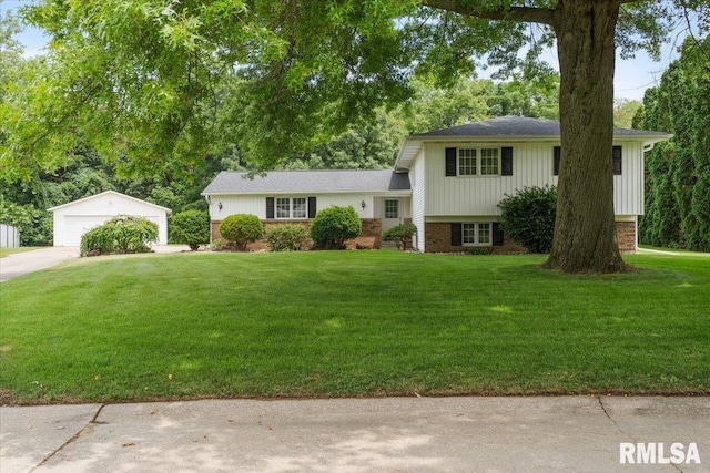 17223 N Cedar Rd, East Moline, IL 61244 - split level home featuring an outdoor structure, a garage, a front lawn, brick siding, and roof with shingles