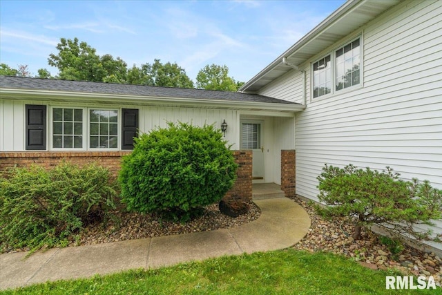 17223 N Cedar Rd, East Moline, IL 61244 - doorway to property with brick siding and board and batten siding