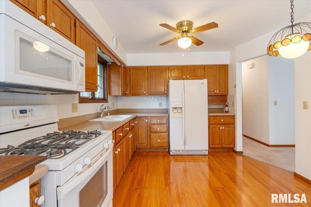 17223 N Cedar Rd, East Moline, IL 61244 - kitchen with white appliances, brown cabinetry, and light wood finished floors