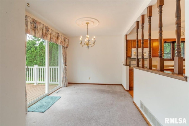 17223 N Cedar Rd, East Moline, IL 61244 - unfurnished room with a chandelier and light colored carpet