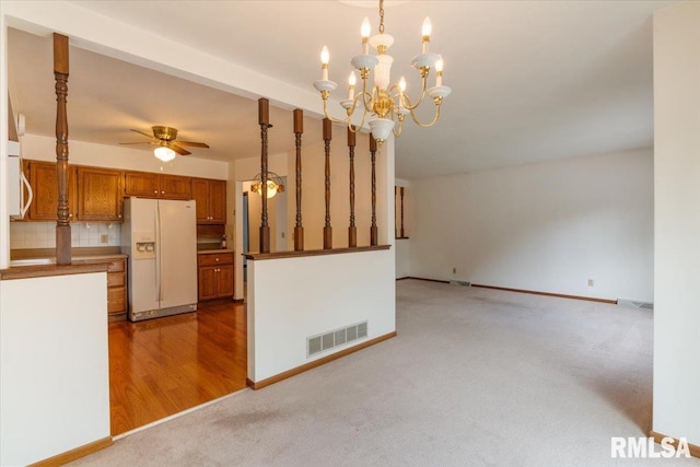 17223 N Cedar Rd, East Moline, IL 61244 - unfurnished living room with a ceiling fan, light colored carpet, and a chandelier