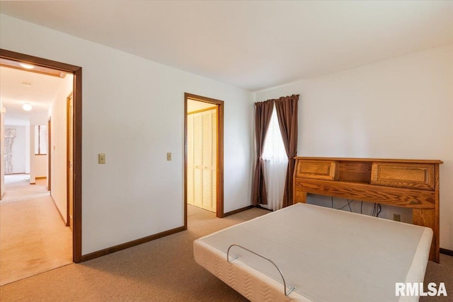 17223 N Cedar Rd, East Moline, IL 61244 - bedroom featuring light carpet and baseboards