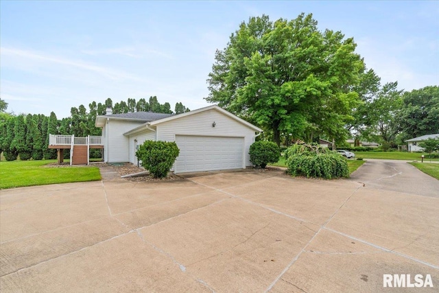 17223 N Cedar Rd, East Moline, IL 61244 - view of side of home with driveway, an attached garage, and a chimney