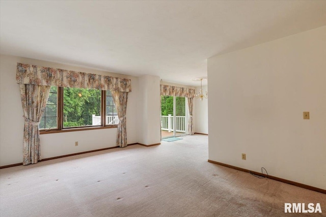 17223 N Cedar Rd, East Moline, IL 61244 - empty room featuring a chandelier and light carpet