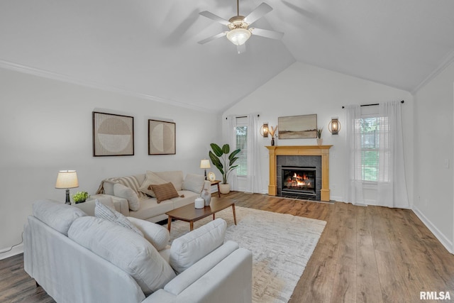 1039 Bluff Ln, Le Claire, IA 52753 - living room featuring a tile fireplace, a ceiling fan, lofted ceiling, wood finished floors, and plenty of natural light