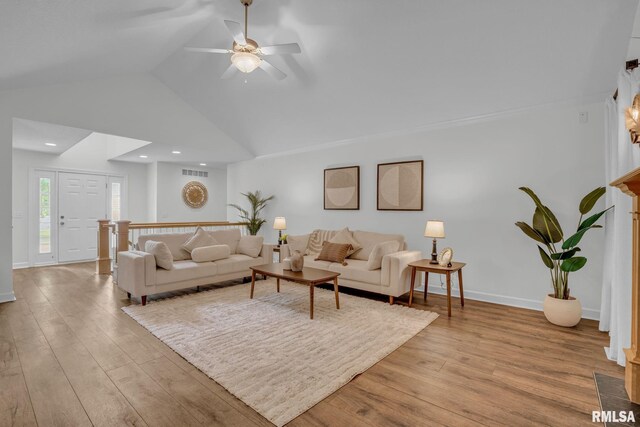 1039 Bluff Ln, Le Claire, IA 52753 - living room featuring light wood-style floors, a ceiling fan, and vaulted ceiling