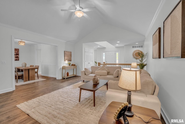 1039 Bluff Ln, Le Claire, IA 52753 - living room featuring vaulted ceiling, a ceiling fan, wood finished floors, and crown molding