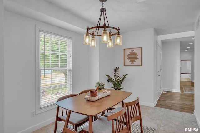 1039 Bluff Ln, Le Claire, IA 52753 - dining space with healthy amount of natural light, a chandelier, and light tile patterned floors