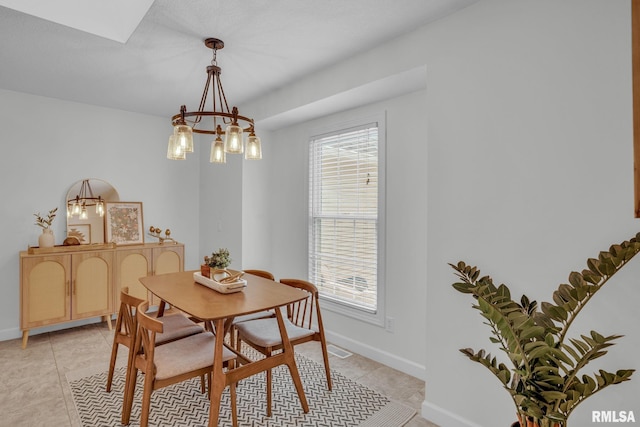 1039 Bluff Ln, Le Claire, IA 52753 - dining area featuring a chandelier and light tile patterned flooring