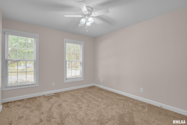 1039 Bluff Ln, Le Claire, IA 52753 - carpeted empty room with a ceiling fan and a textured ceiling
